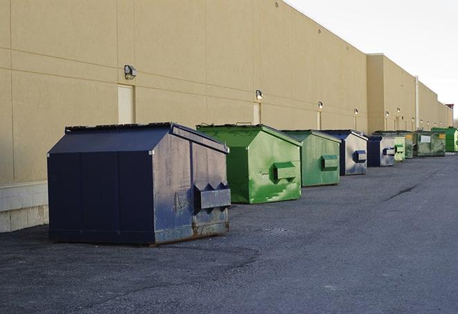 a pile of demolition waste sits beside a dumpster in a parking lot in Fanwood, NJ